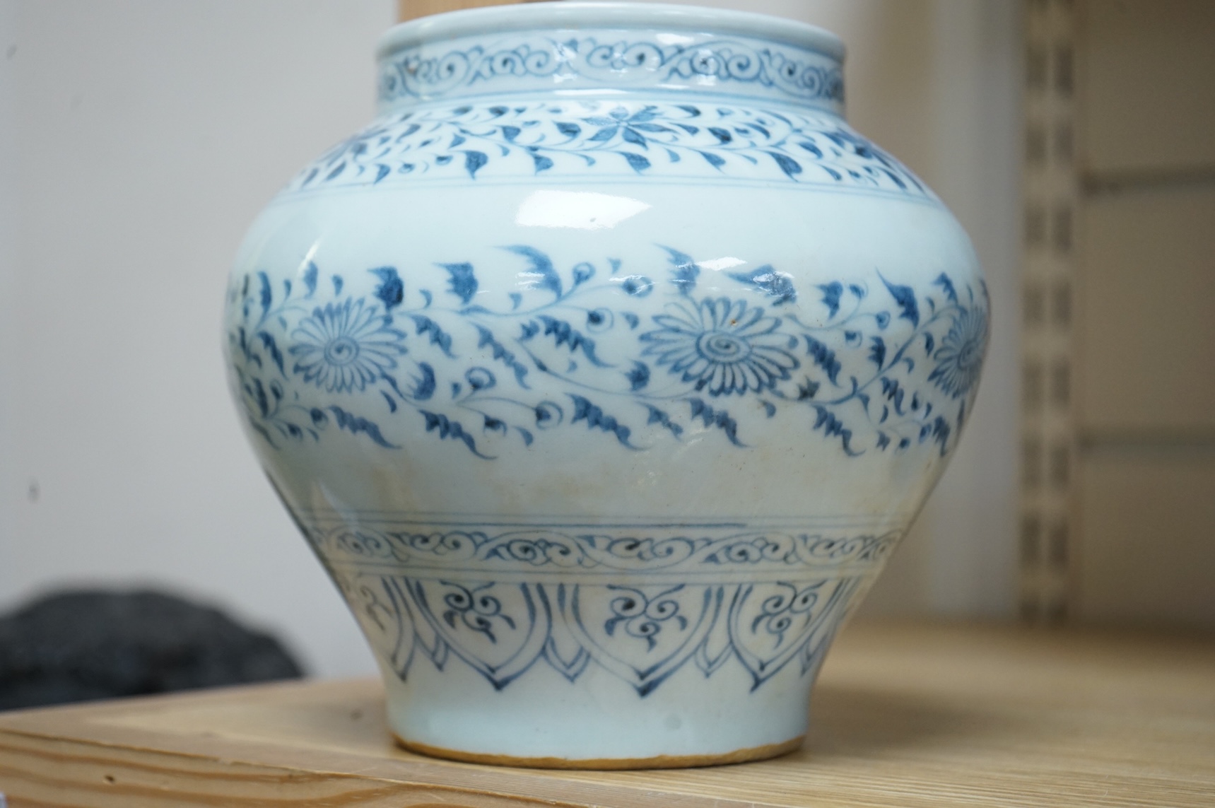 A Chinese blue and white squat vase with floral decoration, 16cm high